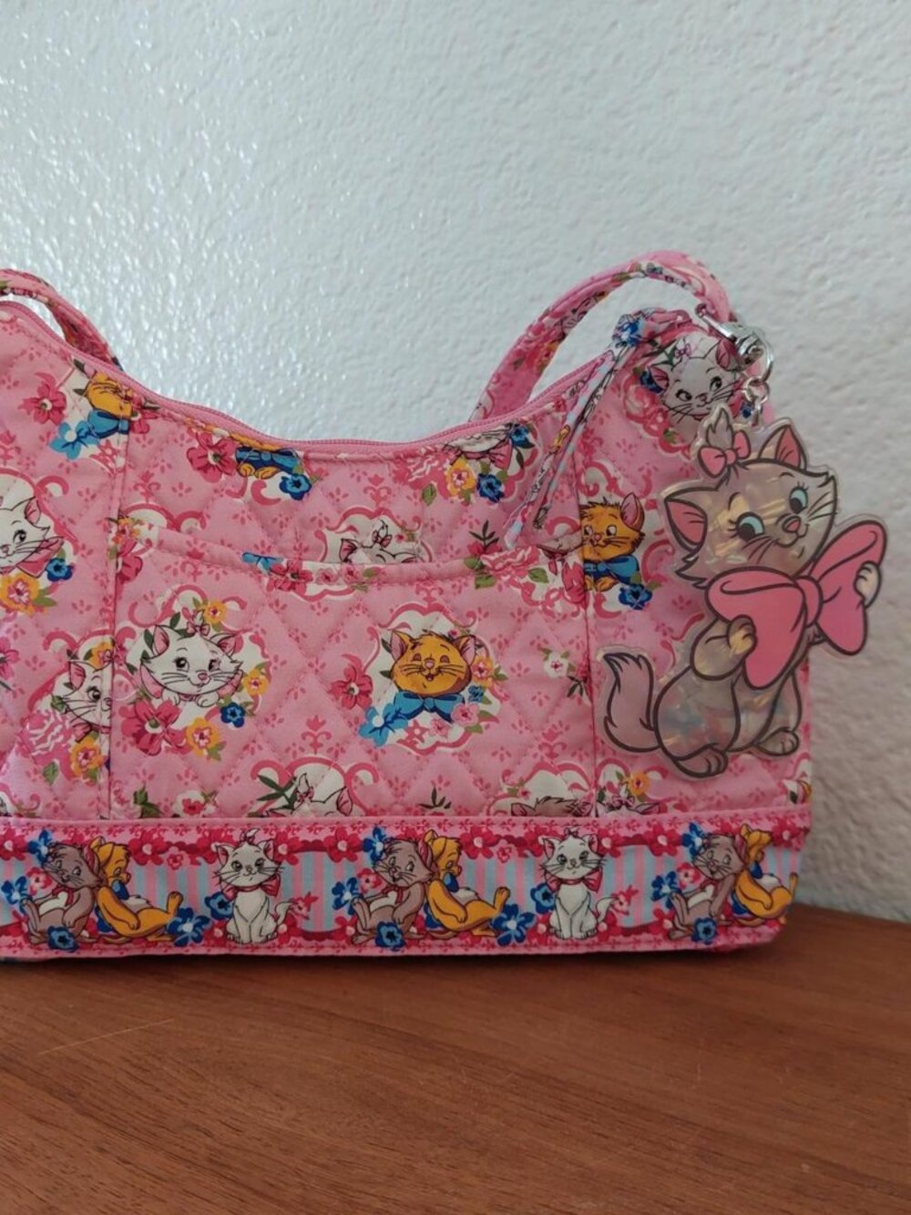 SOLD adley Disney Post Shoulder Bag featuring a pink patterned design with cha